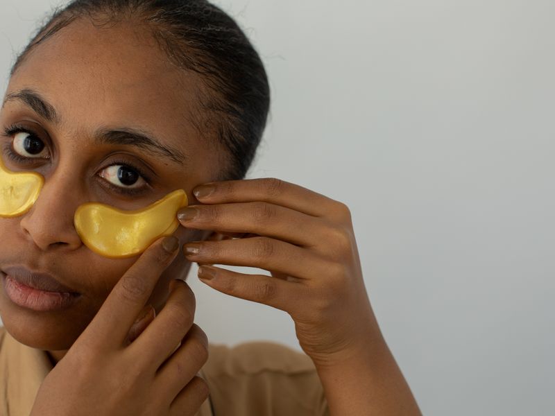 Woman applying under-eye patches