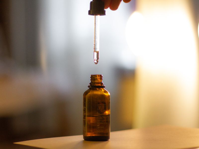 Dropper over an amber serum bottle