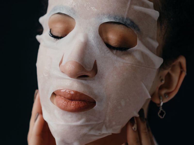 Woman relaxing in a sheet face mask
