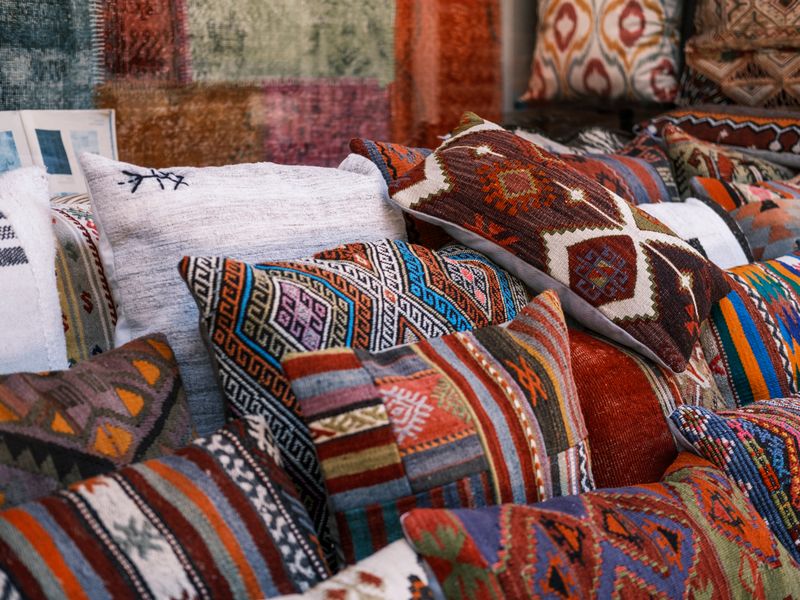 Pile of colorful kilim-pattern pillows
