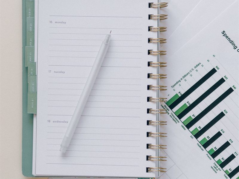 Open planner with a pen