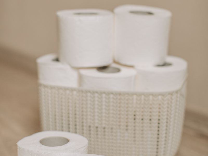 Toilet paper rolls in a white basket