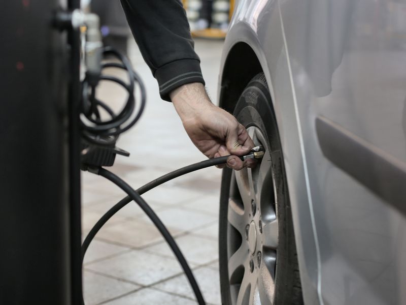 Hand inflating a car tire