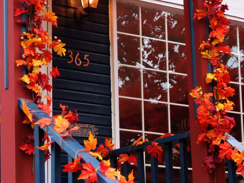 Autumn leaf garland on porch railings