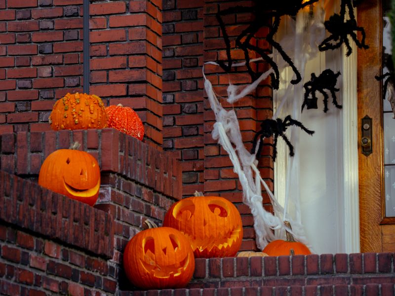 Front steps with jack-o-lanterns and giant spiders