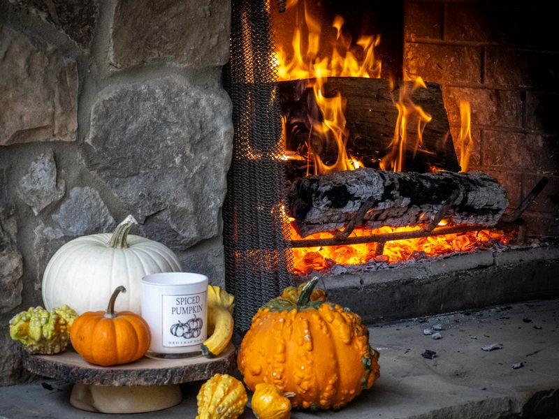 Fireplace with pumpkins and gourds on the hearth