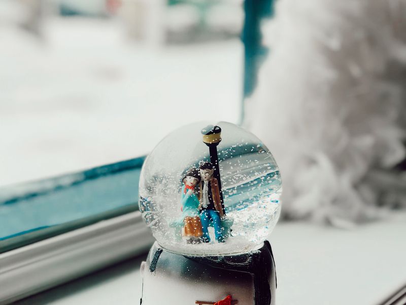 Snow globe on a frosty windowsill